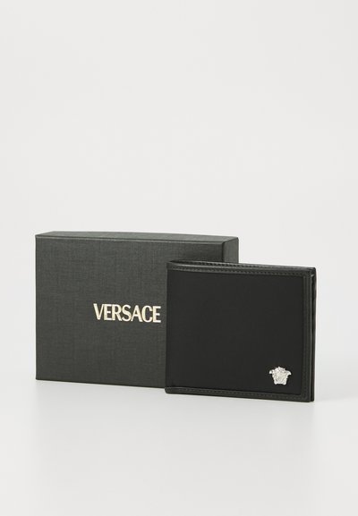 Black leather wallet with a silver Medusa logo. Comes in a textured black gift box featuring “VERSACE” in gold lettering.
