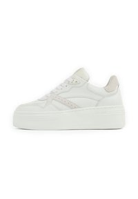 White leather sneaker with a platform sole, featuring a suede accent on the heel and a light-colored suede stripe on the side.