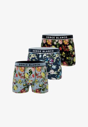 Trois paires de boxers avec des motifs floraux colorés et des ceintures de marque "SERGE BLANCO" en noir, bleu marine et bleu clair.