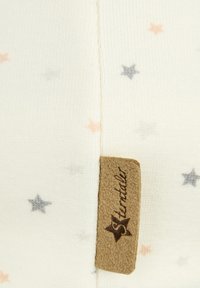 Cotton fabric in cream with small pink, gray, and blue star patterns. Includes a tan leather tag with engraved brand name.