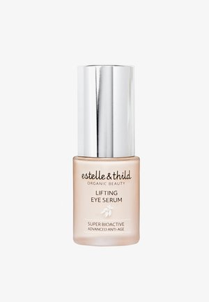 Sérum liftant pour les yeux dans un flacon en verre dépoli, avec une pompe et un capuchon en argent. Étiquette affichant le nom du produit et de la marque en lettres noires.