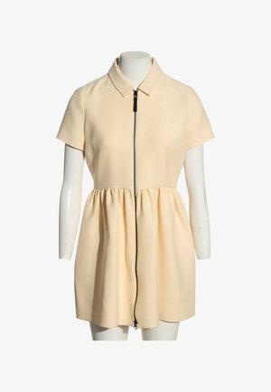 Vestido crema de manga corta con cuello y cintura fruncida, con una cremallera negra de longitud completa en la parte delantera.