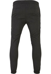 Dark grey tapered pants with a textured fabric, featuring side pockets and elastic cuffs for a fitted look. Simple, minimal design.