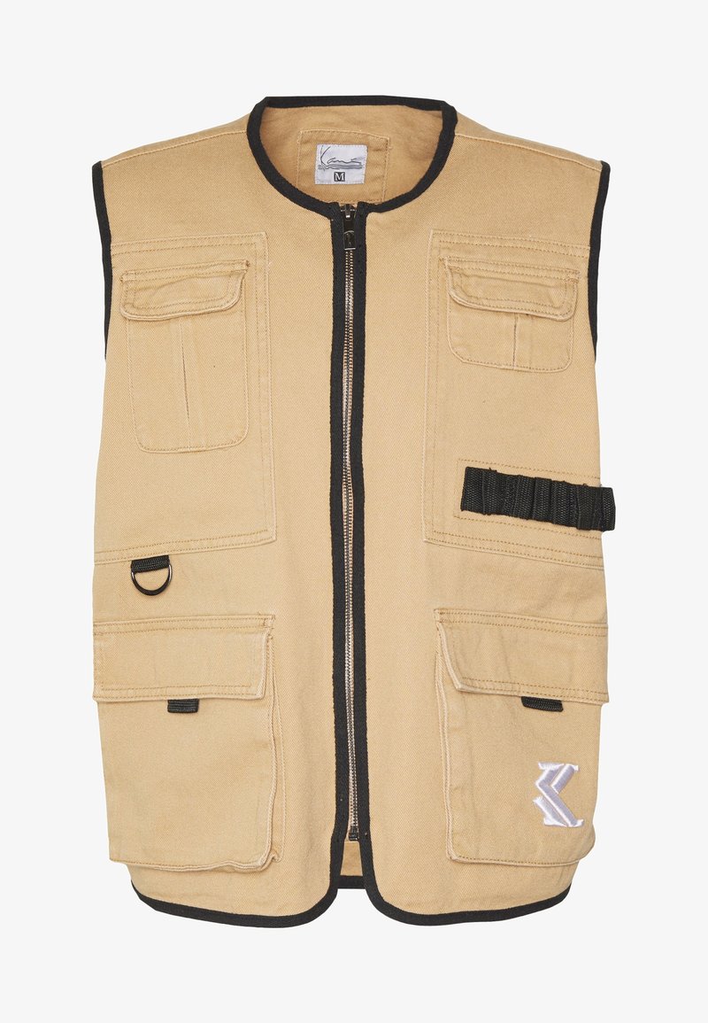 Khaki vest with a front zipper, black trim, multiple front pockets, and a decorative logo. Made of durable fabric with a smooth texture.