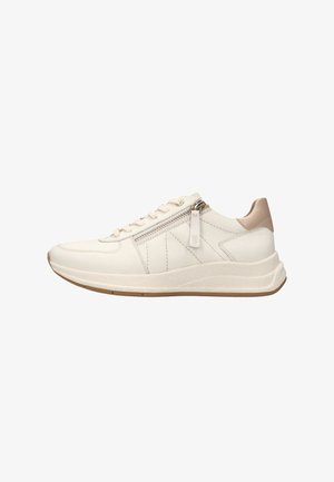 White leather sneaker with a textured finish, featuring a side zipper, tonal laces, and a light tan accent on the heel. Soft, cushioned sole.