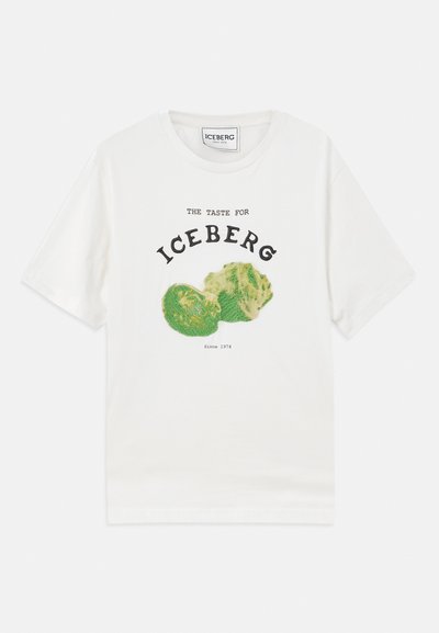 Weißes Baumwoll-T-Shirt mit einer Grafik von Eisbergsalat und schwarzem Text, der "DER GESCHMACK FÜR EISBERG" und "Seit 1974" liest.