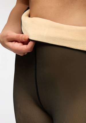 Collant neri con una morbida vita in pile beige. Il materiale testurizzato presenta righe verticali e dettagli con cuciture piatte sui bordi.