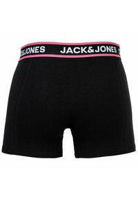 Svarta bomullshängsel med en bred midja som har vit och rosa "JACK & JONES"-logotyp. Slät textur och tight passform.
