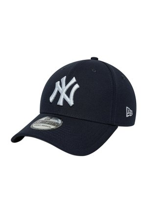Navy blue baseball cap with white embroidered New York Yankees logo front and side, and a silver size label on the brim.