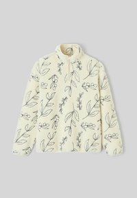 Polaire crème avec des dessins botaniques noirs en lignes, manches longues et col à demi-fermeture éclair sur un fond gris clair.