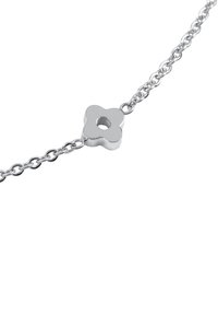Silver chain bracelet with a flower-shaped centerpiece featuring a central hole, combining sleek design with metallic texture.