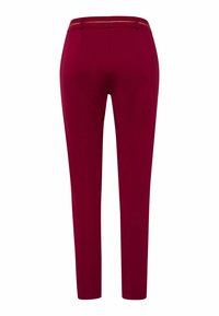 Crimson slim-fit trousers with a smooth texture, featuring a flat waistband and subtle side accents. Tailored for a sleek silhouette.