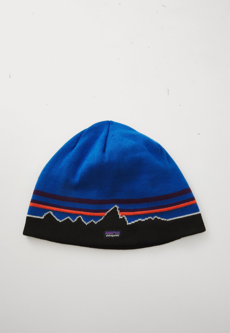 Blue knit beanie with black base and mountain silhouette pattern, accented by red and purple horizontal stripes.