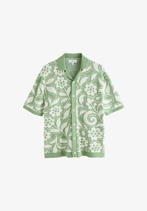 Short-sleeve button-up shirt with green collar and cuffs, featuring a green and white floral and leaf pattern.