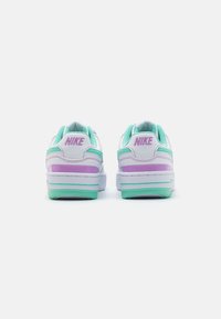 Nike sneakers with a white leather upper, mint green and lavender accents, featuring a padded collar and a textured sole for grip.