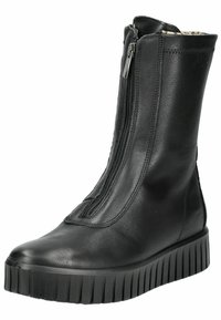 Black leather ankle boots with a tall shaft, zip closure, and textured rubber platform sole. Seam detailing adds depth to the design.