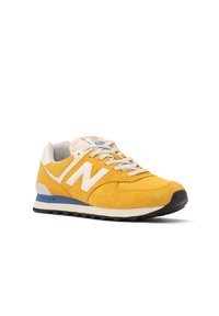 Yellow suede sneaker with white accents, grey laces, and a blue midsole. Features a padded collar and textured rubber outsole for traction.