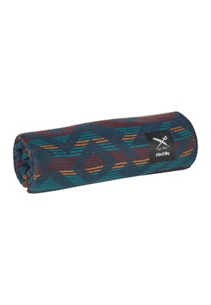 Rolled patterned blanket with teal, orange, and red geometric designs and a black label showing crossed paddles and text "est. 1994 Iriedaily."