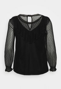 Blusa nera con maniche trasparenti a pois, scollatura arricciata, schiena a V e chiusura con bottone. Motivo a pois testurizzato in tutto il capo.