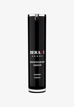 Czarna cylindryczna butelka serum z srebrną zakrętką i podstawą. Etykieta zawiera napis "BERANI HOMME" oraz opis produktu w białym tekście.