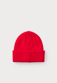 Red knit beanie with a folded cuff, featuring a smooth texture and a rounded top. Simple design, no patterns or embellishments.