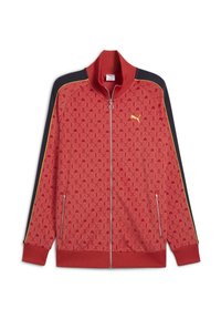 Chaqueta de chándal roja con cremallera y un patrón por toda la prenda, mangas negras, ribetes amarillos y un cuello acanalado, con bolsillos laterales.