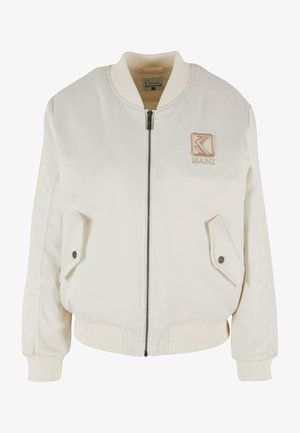 Tejbézs bomberdzseki elülső zipzárral, bordás gallérral és mandzsettákkal. Két oldalsó zsebet és hímzett logót tartalmaz a mellkason.