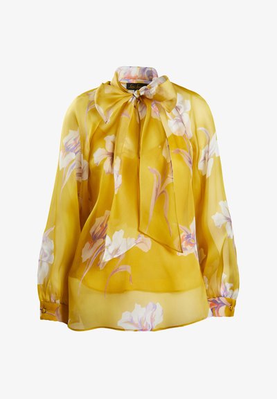 Gelbe Seidenbluse mit floralen Mustern in Lila- und Weißtönen, mit einer Schleifenkragen, langen Ärmeln und geknöpften Manschetten.