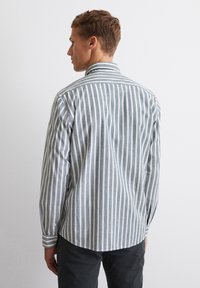 Striped long-sleeve shirt in blue and white, with a classic collar and button cuffs, featuring a curved hem and lightweight fabric.