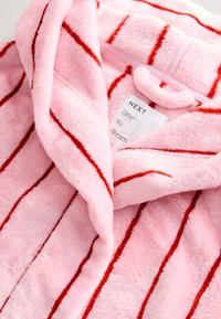 Pink fleece robe featuring red stripes, a shawl collar, and a soft texture. Label reads "NEXT time to dream."