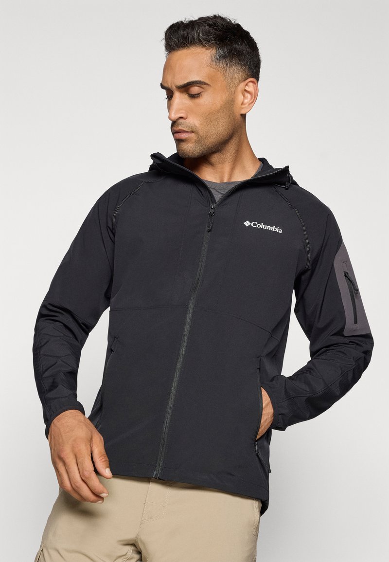 Czarna kurtka Columbia z zamkiem i kapturem. Posiada strukturalne rękawy, zamykaną kieszeń na ramieniu oraz kontrastowe szwy.