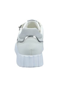 White sneaker with thick, ridged sole, silver metallic accent strip, gray heel patch, and padded collar, shown from the back.