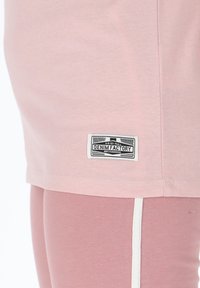 Light pink t-shirt made of soft cotton with a stitched hem. Features a black and white "DENIM FACTORY" label on the lower left side.