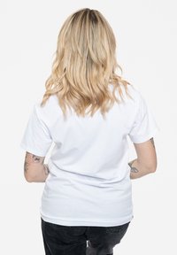 Short-sleeve white cotton t-shirt with a relaxed fit, featuring a smooth texture and no visible patterns or graphics.