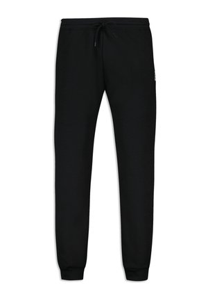 Pantalones de chándal negros hechos de una tela suave, con cintura ajustable mediante cordón, puños ajustados y una marca mínima en el muslo izquierdo.