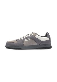Low-top grey and white sneaker with white laces, black sole, and "HUGO" logo on the side panel, displayed against a white background.