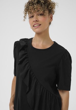 Black t-shirt featuring a ruffled design on one side, short sleeves, a round neckline, and a smooth texture.