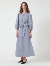 Striped dress featuring blue and white vertical lines, balloon sleeves, a cinched waist with a bow detail, and a floor-length silhouette.