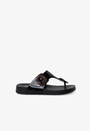 Black glossy slide sandal with toe post and large tortoiseshell buckle on wide strap over the foot, ridged sole for grip.