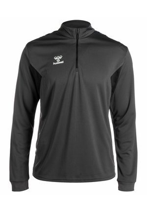 Sort langærmet pullover med lynlås-krave, struktureret front og kontrasterende sidelapper, prydet med et hvidt Hummel-logo på brystet.