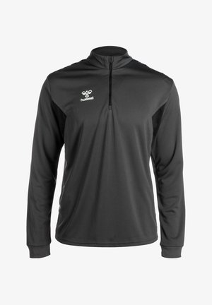 Sort langærmet pullover med lynlås-krave, struktureret front og kontrasterende sidelapper, prydet med et hvidt Hummel-logo på brystet.