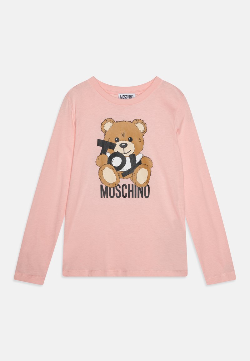 Dlhý rukáv, svetloružové tričko s potlačou medveďa, ktorý drží fotoaparát, s textom "MOSCHINO" pod ním v čiernej farbe. Jemná bavlnená tkanina.