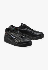 Scarpe sportive nere con tomaia in pelle, dettagli perforati, chiusura con lacci e una suola in gomma spessa con dettagli del logo.
