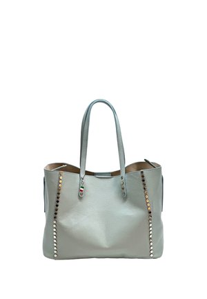 Light gray leather tote bag with double handles, decorated with two vertical rows of metallic studs on front sides and a small tricolor charm.