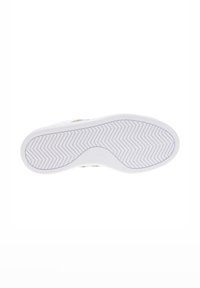 Suela de zapatilla blanca con un patrón de espiga texturizado, bordes curvados y un perfil plano, que presenta sutiles acentos dorados.