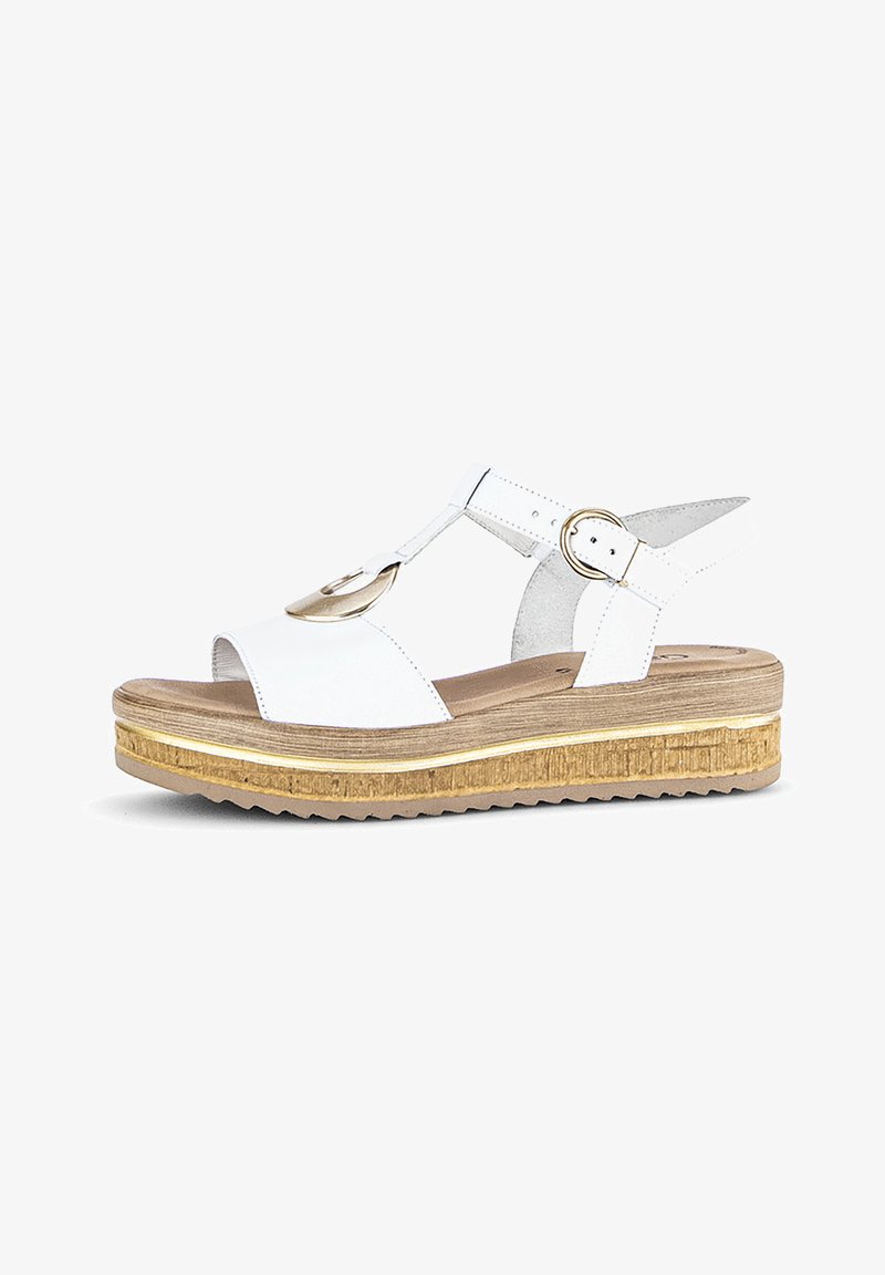 White platform sandals with a cork-like sole, rounded design, adjustable ankle strap, and circular gold accent detail.