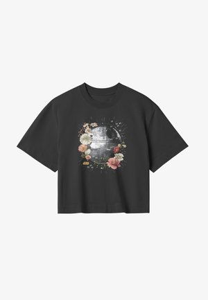 Schwarzes T-Shirt mit kurzen Ärmeln, das ein grafisches Design eines kreisförmigen Symbols umgeben von Blumen zeigt, sowie den Text "Star Wars" in Gelb.