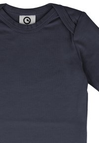 Long-sleeve, dark navy blue cotton onesie with a round neck and snap closure; smooth texture, features a circular logo tag at the neck.