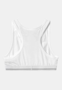 Hvit sports BH med racerback design, laget av myk stoff. Har minimal søm og et gråstrippet bånd nederst.