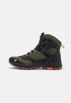Hoge wandelschoen met groene stof, zwarte ondersteuning, oranje veteraccenten en een bruine rubberen zool, zijaanzicht op een witte achtergrond.